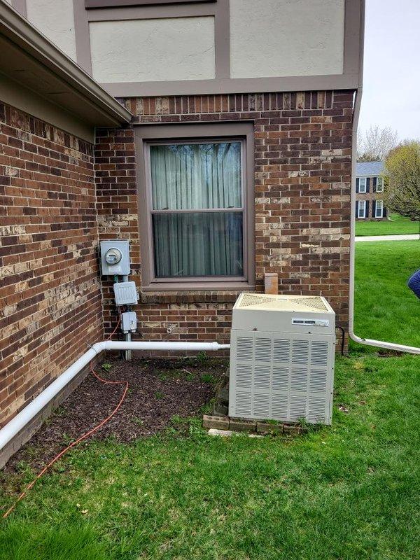 Completed comprehensive HVAC system evaluation for replacement estimate on aging residential equipment including 1980s-era air conditioning unit low on R22 refrigerant and 1997 furnace with documented venting issues causing flame rollout concerns. Documented exterior condenser unit positioned on concrete pad with associated refrigerant lines and electrical connections, and basement furnace installation with ductwork configuration to provide accurate replacement specifications for complete system upgrade.
