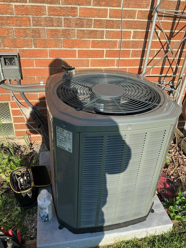 Completed comprehensive Gold AC Inspection on residential cooling system with equipment under 10 years of age. Performed full system evaluation including outdoor condenser unit inspection, verified proper refrigerant line connections and electrical disconnect functionality, tested system operation with multimeter readings, and inspected basement-located air handler unit for proper airflow and mechanical integrity. System confirmed operational with all components functioning within normal parameters at time of inspection.