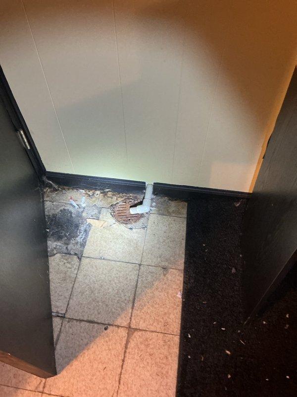 Responded to water heater leak reported at bottom of unit. Upon inspection, confirmed active leakage from base of residential water heater tank, indicating internal tank failure. Documented existing installation elevated on wooden platform with copper supply lines and proper venting connections. Assessed surrounding floor area showing water damage and drainage conditions. Provided estimate for complete water heater replacement including removal of failed unit, installation of new tank with code-compliant connections, and proper disposal of old equipment.