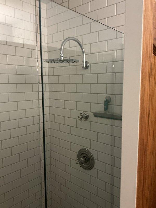 Replaced faucet assembly on vintage pedestal sink with chrome cross-handle fixtures and center spout. Verified proper water flow and tested for leaks to ensure complete installation and functionality.