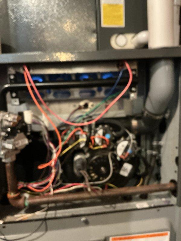 Completed comprehensive NSP furnace inspection on basement-located heating system. Performed thorough visual examination of furnace interior components including gas valve assembly, heat exchanger, electrical connections, and burner assembly. Inspected all wiring connections, pilot light assembly, and control components for proper operation and safety compliance. Documented equipment condition with photographic evidence showing internal mechanical components and external condenser unit. All accessible components examined and found to be functioning within normal parameters.