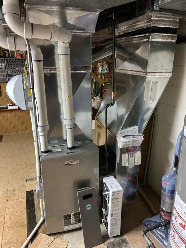 Completed comprehensive Gold AC inspection on 4-year-old residential HVAC system with basement-located air handler and Lennox furnace. Performed multi-point inspection including condenser examination, refrigerant level verification, electrical connection testing, airflow assessment through ductwork system, and filter evaluation. System found to be operating within normal parameters with no immediate service requirements identified; documented equipment condition with photographic records for maintenance history.