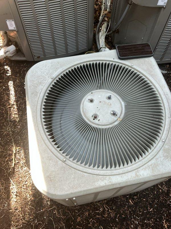 Completed Gold AC Inspection on multi-unit residential system with equipment aged 3-5 years, including air handlers located in basement and second floor. Performed comprehensive visual inspection of outdoor condenser units, identifying significant debris accumulation and organic matter lodged between condenser coil fins, which restricts airflow and reduces heat transfer efficiency. Documented condition of refrigerant lines, electrical connections, and overall unit integrity through photographic evidence. Noted surface weathering and dirt accumulation on exterior casings consistent with normal outdoor exposure. All equipment operational at time of inspection, with condenser fan grilles and access panels intact and properly secured.