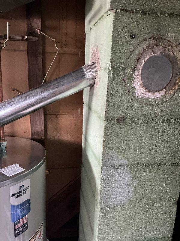 Installed a 50-gallon short Bradford White tanked water heater in basement utility area. Connected copper supply lines and exhaust venting system, ensuring all connections meet code requirements. Unit was properly positioned, secured, and tested for safe operation with all plumbing and venting systems functioning correctly.