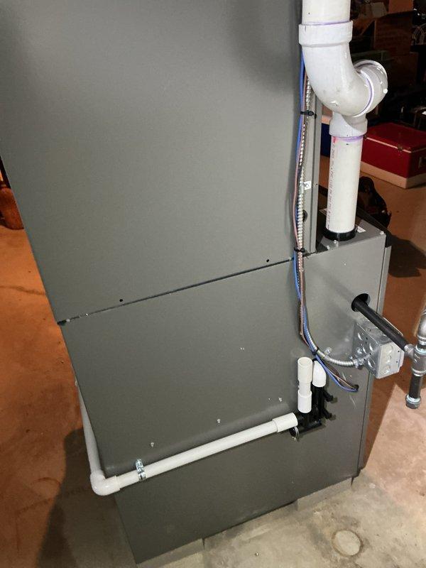 Completed comprehensive Gold AC inspection on Lennox CX40CT-36B-01 air handler unit located in basement. System confirmed operational with equipment under 10 years old. Performed standard inspection protocol including visual examination of unit components, condensate drainage system, and electrical connections. Verified proper PVC condensate line configuration and assessed overall system condition. Provided customer instruction on thermostat programming and advised that outdoor condenser area must be maintained clear of debris and animal waste for optimal performance. Unit labels and safety warnings verified present and legible. All accessible components inspected and found in satisfactory working condition.