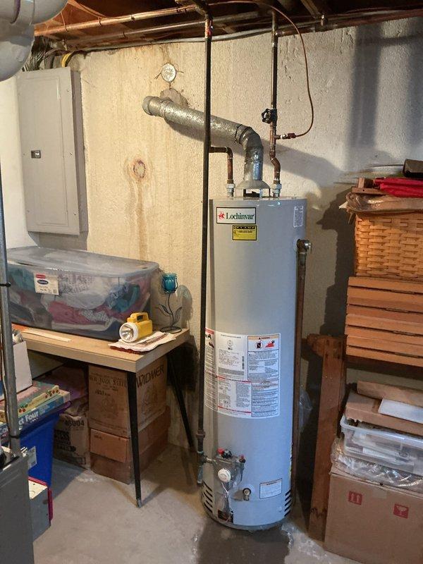 Installed a 40-gallon gas-fired tanked water heater in basement utility area with proper venting connection to existing chimney flue system. Reconnected all water supply lines and gas piping to new unit, ensuring proper operation and code compliance. Customer was advised that a chimney liner installation will be required per HVAC technician recommendations from previous furnace inspection, and a drip pan installation is recommended for future consideration.