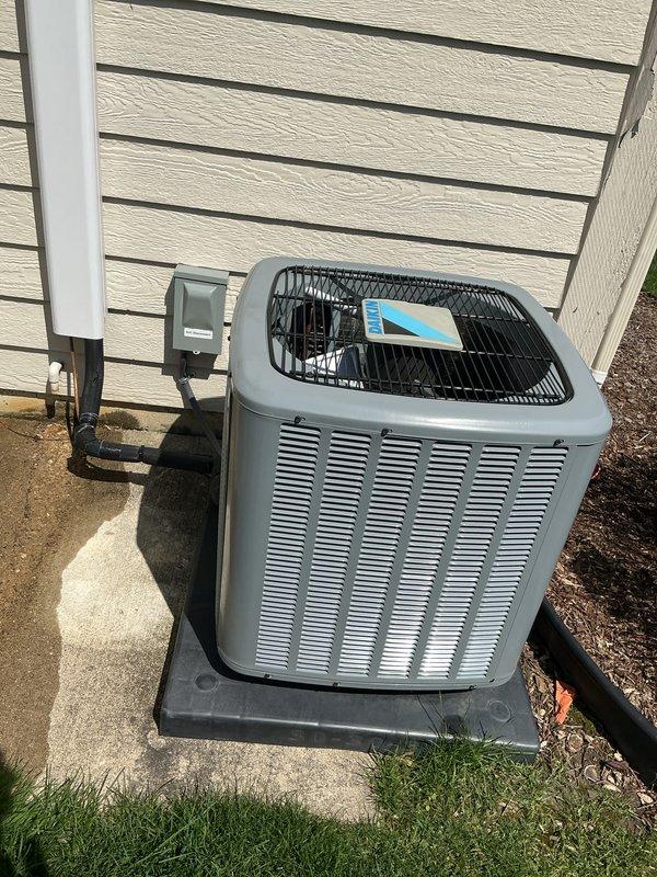 Completed comprehensive Gold AC inspection on a multi-unit residential HVAC system with air handler located in small crawlspace and basement area. Performed thorough examination of outdoor condenser unit, which was found properly positioned on concrete pad with adequate clearance and protective wire mesh guard in place. Verified system operational status, inspected electrical connections and disconnect box, confirmed proper conduit routing, and assessed overall equipment condition. Unit showed normal wear consistent with age, with no visible damage, rust, or debris accumulation on exterior surfaces or surrounding area.