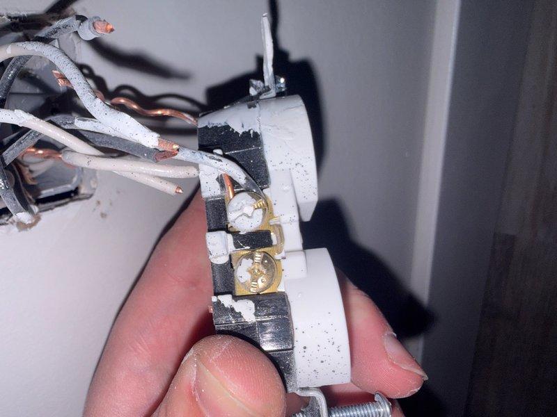 Replaced defective electrical terminal block assembly on baseboard heating unit. Removed failed white plastic housing containing corroded brass terminals and reconnected all wiring to new component with proper torque specifications. Verified all electrical connections were secure and heating element operation was restored to normal function.