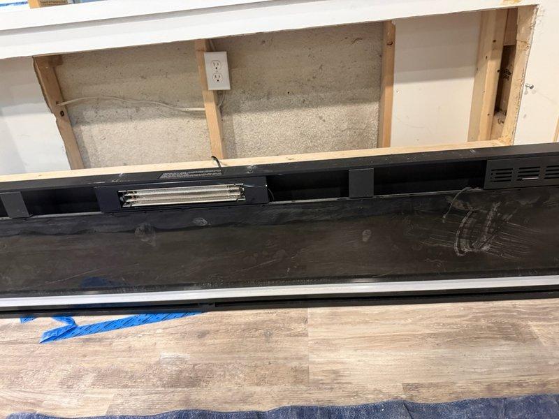 Replaced defective electrical terminal block assembly on baseboard heating unit. Removed failed white plastic housing containing corroded brass terminals and reconnected all wiring to new component with proper torque specifications. Verified all electrical connections were secure and heating element operation was restored to normal function.