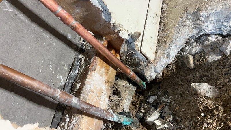 Completed floor break repair to access and replace heavily corroded copper water supply lines. Removed deteriorated piping exhibiting significant oxidation, verdigris formation, and rust deposits throughout the affected section. Installed new copper piping to restore proper water flow and prevent future leaks from corroded connections.