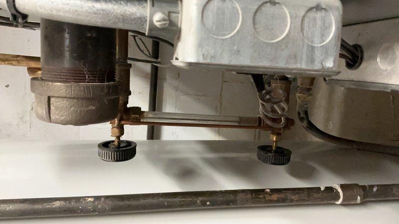 Completed comprehensive tune-up and inspection on 11-year-old boiler system for insurance compliance purposes. Performed visual inspection of gas manifold assembly, burner components, and gas valve controls, documenting condition of copper tubing, pressure regulators, and adjustment mechanisms. All components found to be in proper working order with normal age-related surface oxidation present but no functional deficiencies noted.