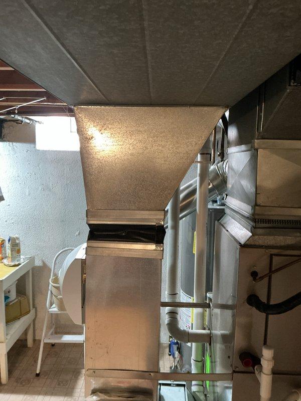 Conducted comprehensive estimate for furnace and air conditioning system replacement due to failed secondary heat exchanger in existing 10+ year old equipment. Performed detailed inspection of basement-located air handler, existing ductwork system, and associated HVAC components to provide accurate replacement recommendations. Documented current system configuration including galvanized metal ductwork, PVC drainage lines, and mechanical room layout to ensure proper equipment sizing and installation planning for proposed furnace and AC replacement.