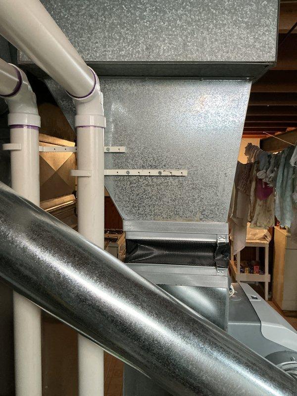 Conducted comprehensive estimate for furnace and air conditioning system replacement due to failed secondary heat exchanger in existing 10+ year old equipment. Performed detailed inspection of basement-located air handler, existing ductwork system, and associated HVAC components to provide accurate replacement recommendations. Documented current system configuration including galvanized metal ductwork, PVC drainage lines, and mechanical room layout to ensure proper equipment sizing and installation planning for proposed furnace and AC replacement.