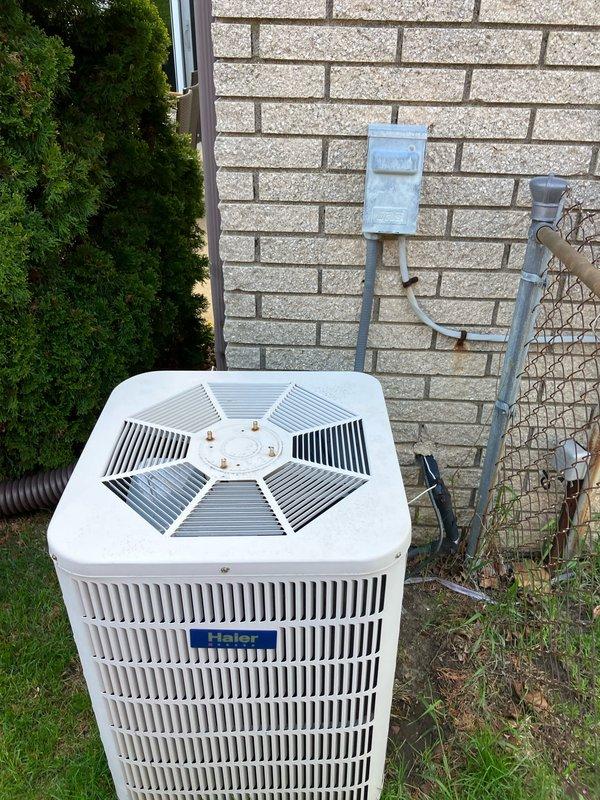 Conducted comprehensive site assessment for full HVAC system replacement estimate at residential property. Evaluated existing outdoor air conditioning condenser unit positioned on exterior wall-mounted concrete pad and basement furnace installation. Both heating and cooling systems currently operational at time of inspection. Documented existing equipment configuration including electrical disconnect, gas meter connections, refrigerant line sets, condensate drainage, and conduit routing along building exterior. Photographed equipment positioning, clearances, and utility connections to prepare detailed proposal for complete system upgrade. Customer requested appointment scheduling after 5pm for convenience.