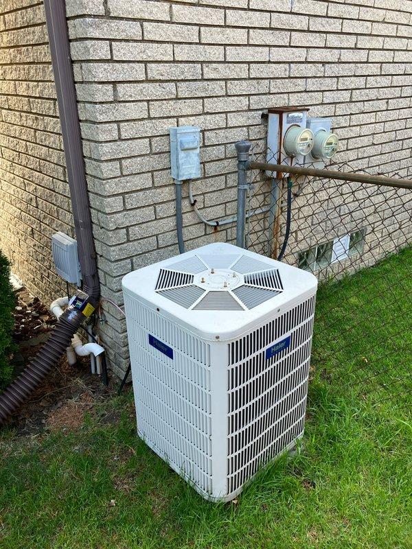 Conducted comprehensive site assessment for full HVAC system replacement estimate at residential property. Evaluated existing outdoor air conditioning condenser unit positioned on exterior wall-mounted concrete pad and basement furnace installation. Both heating and cooling systems currently operational at time of inspection. Documented existing equipment configuration including electrical disconnect, gas meter connections, refrigerant line sets, condensate drainage, and conduit routing along building exterior. Photographed equipment positioning, clearances, and utility connections to prepare detailed proposal for complete system upgrade. Customer requested appointment scheduling after 5pm for convenience.