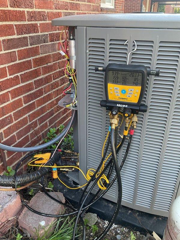 Performed AC system startup on outdoor condensing unit located at basement level. Connected Fieldpiece diagnostic manifold gauges and verified refrigerant pressures and temperatures within manufacturer specifications. Inspected electrical connections at disconnect boxes, refrigerant line sets, and outdoor unit. System operational and cooling properly. Customer inquiry regarding property violation requires follow-up discussion.