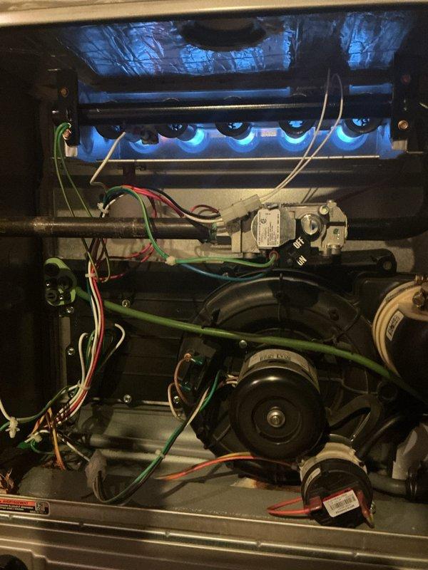 Completed comprehensive Gold AC and furnace inspection on 9-year-old residential HVAC system. Performed thorough evaluation of gas furnace, confirming proper burner operation with even blue flame distribution across all burners, verified gas valve functionality and electrical connections, and inspected draft inducer motor assembly. Conducted complete outdoor air conditioning unit assessment, examining condenser fan operation, refrigerant lines, electrical disconnect, and cabinet condition. Both heating and cooling systems operating within normal parameters with no immediate concerns identified. Documented equipment condition with photographic records for maintenance history. All components functioning properly at time of inspection.
