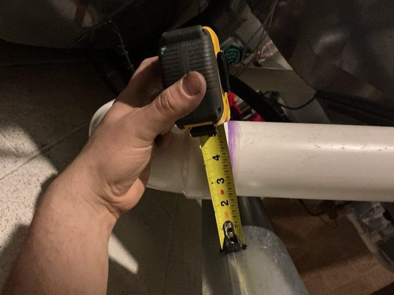 Corrected a code violation where the water heater B-vent was in direct contact with the furnace PVC vent pipe. Repositioned and secured the B-vent to maintain the required 1-inch clearance from combustible materials and adjacent piping, bringing the installation into compliance with safety standards.
