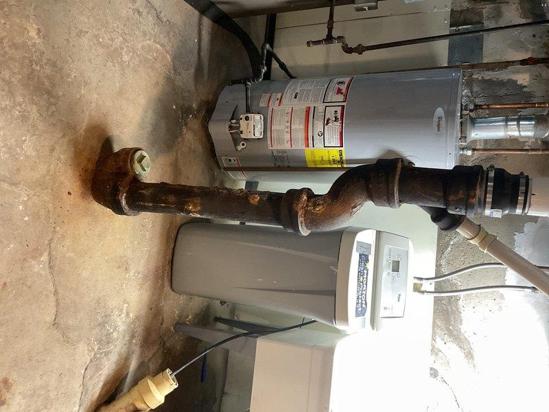 Conducted comprehensive assessment of existing cast iron plumbing stack system for replacement estimate. Inspection revealed extensive corrosion and deterioration of cast iron piping throughout the basement utility area, particularly affecting horizontal runs and vertical stack connections near the water heater. Documented severely rusted pipe sections showing advanced oxidation and structural compromise. Evaluated existing drainage system configuration including overhead piping layout, exposed joists, and connection points to current plumbing infrastructure. Photographed corroded cast iron components, water heater connections, and basement utility space conditions to provide detailed visual documentation for estimate preparation. Provided recommendations for complete cast iron stack replacement with modern piping materials.
