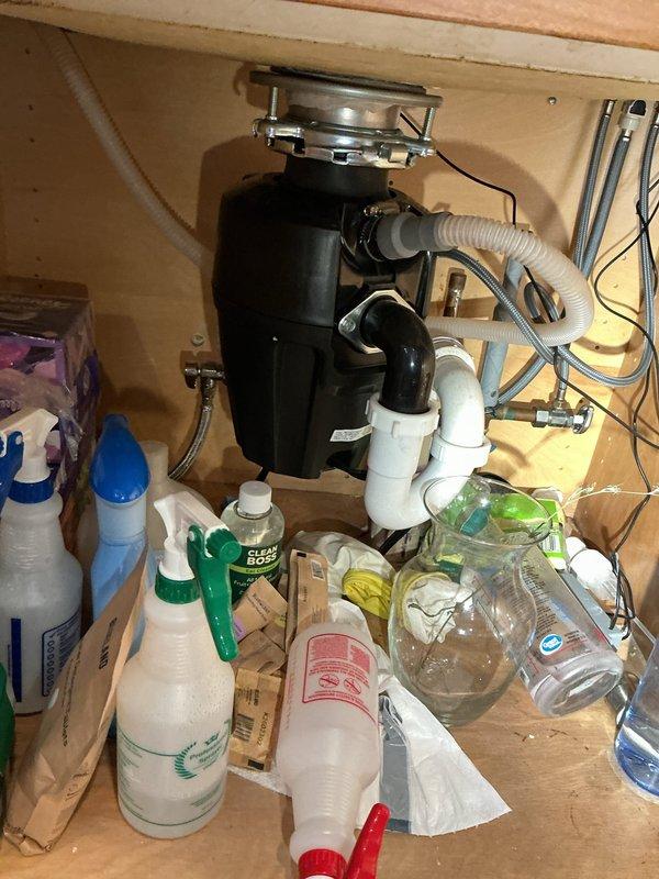 Responded to service call for plumbing assessment beneath kitchen sink. Inspected dishwasher discharge line connection to garbage disposal unit and evaluated condition of shut-off valves serving sink supply lines. Examined under-sink plumbing configuration including P-trap assembly, disposal mounting, and water supply connections with braided stainless steel flex lines. Accessed crawlspace area to assess copper supply piping, support brackets, and overall condition of water distribution system serving kitchen fixtures. Documented existing plumbing infrastructure and identified components requiring replacement. Provided detailed evaluation and prepared replacement quotes for dishwasher connection line and aging shut-off valves as requested.