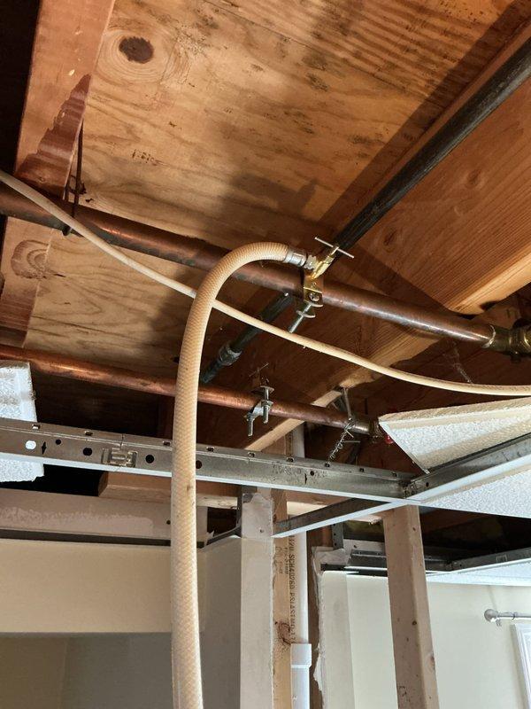 Responded to service call for plumbing assessment beneath kitchen sink. Inspected dishwasher discharge line connection to garbage disposal unit and evaluated condition of shut-off valves serving sink supply lines. Examined under-sink plumbing configuration including P-trap assembly, disposal mounting, and water supply connections with braided stainless steel flex lines. Accessed crawlspace area to assess copper supply piping, support brackets, and overall condition of water distribution system serving kitchen fixtures. Documented existing plumbing infrastructure and identified components requiring replacement. Provided detailed evaluation and prepared replacement quotes for dishwasher connection line and aging shut-off valves as requested.