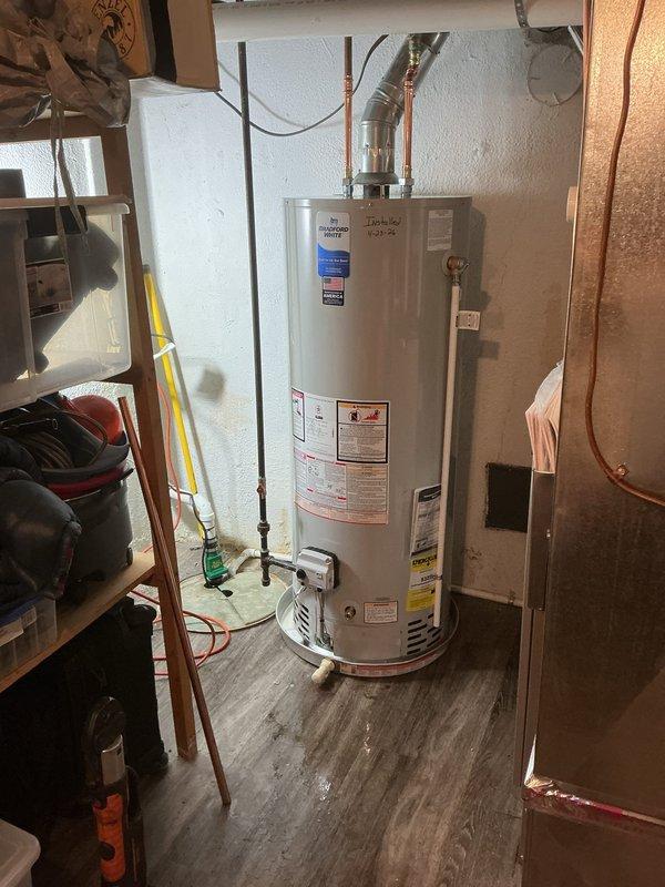 Installed new tanked water heater in utility closet with copper supply line connections and PVC temperature/pressure relief valve discharge piping routed to proper termination point. Note: Drip pan installation still required to complete job per code requirements.