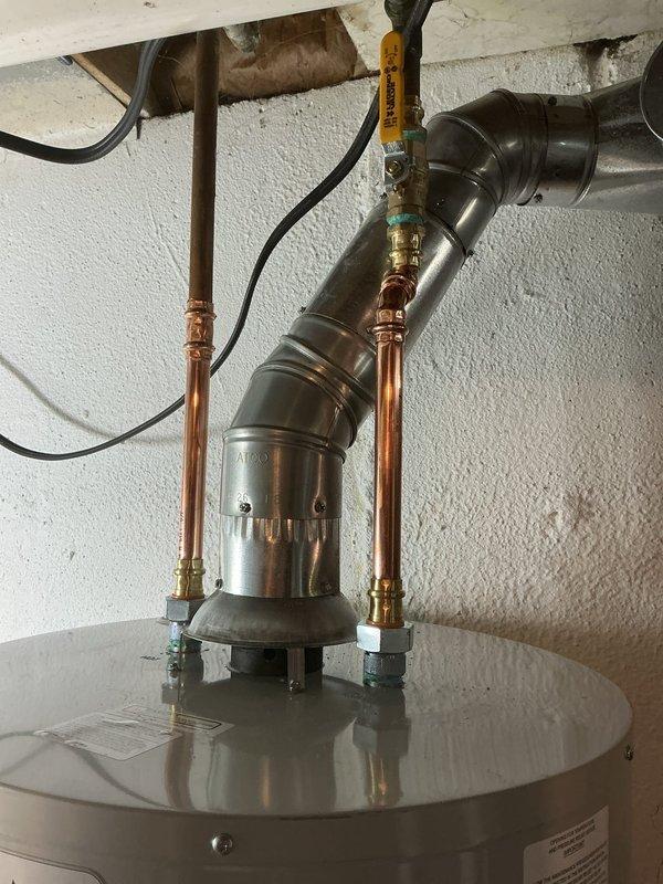 Installed new tanked water heater in utility closet with copper supply line connections and PVC temperature/pressure relief valve discharge piping routed to proper termination point. Note: Drip pan installation still required to complete job per code requirements.