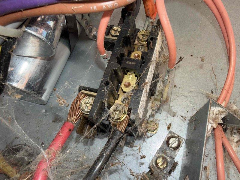 # HVAC Maintenance - Gold AC Inspection

Completed comprehensive Gold AC inspection on 25-year-old residential air conditioning system with air handler/coil located in attic. Performed thorough visual assessment of both indoor and outdoor components per maintenance protocol.

## Outdoor Unit Assessment

Inspected condenser unit and documented significant deterioration of electrical components. Found severe corrosion and oxidation on terminal block connections, with heavy rust accumulation obscuring metal surfaces. Multiple wire connections showing signs of environmental exposure and aging, though conductors remain structurally intact. Capacitor and associated wiring connections examined. Noted accumulated dirt, debris, and cobwebs throughout electrical assembly. All colored conductors traced and connection integrity verified despite visible surface corrosion on terminals.

## Indoor Unit Assessment

Accessed attic-mounted air handler and inspected electrical panel and junction box. Fou