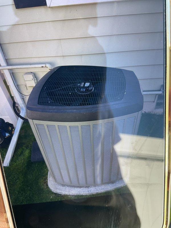 Completed comprehensive Gold AC Inspection on residential outdoor condensing unit with cylindrical cabinet design and vertical louver configuration. Performed full system tune-up including inspection of refrigerant lines, electrical connections, and condenser coil condition. Replaced air filter showing moderate dust accumulation and discoloration in multiple segments of hexagonal frame assembly, ensuring optimal airflow and system efficiency for continued operation.