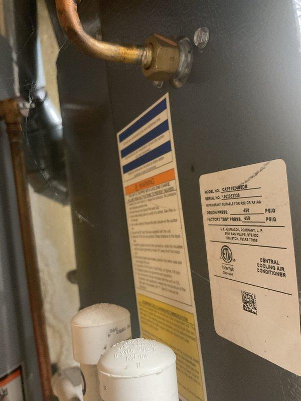 Completed comprehensive Gold AC inspection on an 8-year-old central air conditioning system with air handler located in basement. Performed thorough evaluation of indoor CAPF1560D1R unit, examining refrigerant lines, electrical connections, and all accessible components. Inspected outdoor condenser unit positioned on concrete pad against brick exterior, verifying proper operation of fan assembly, coil condition, and refrigerant line connections. System confirmed operational with no immediate deficiencies noted during inspection.