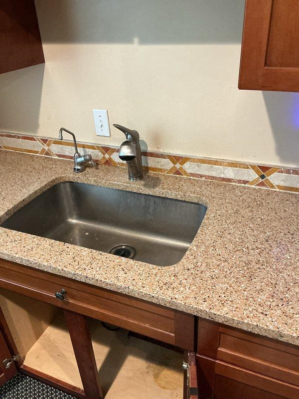 Replaced kitchen faucet with new bronze single-handle unit, ensuring proper mounting and secure connections to existing water supply lines. Tested installation for leaks and verified proper drainage function, with system operating correctly upon completion.