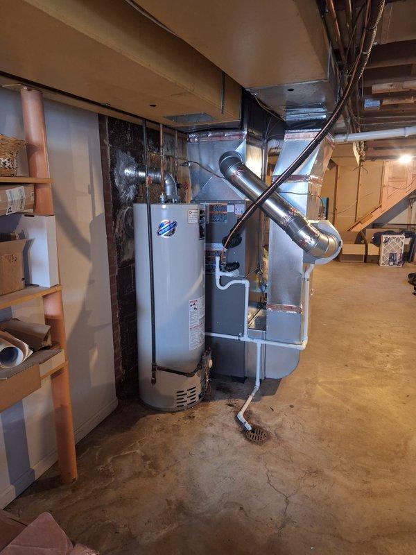 Completed installation of new air conditioning system and evaporator coil in residential basement location. Established all electrical connections at terminal block, routed refrigerant lines with proper insulation, and installed condensate drain lines using PVC piping. System was fully wired, tested for proper operation, and permit was requested for the installation per local code requirements.