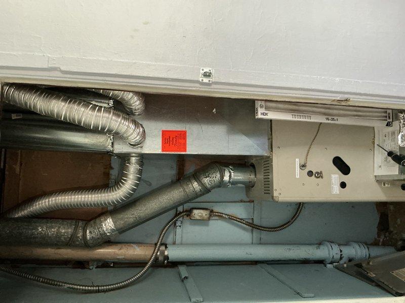 Performed diagnostic evaluation on 10+ year old furnace located in first floor closet. Conducted thorough system inspection and testing to assess reported operational issues. Determined pressure switch requires replacement based on diagnostic findings. Documented equipment condition with photographs showing air handler unit, flexible aluminum ductwork, cylindrical muffler component, and associated electrical connections. Provided repair quote to homeowner for pressure switch replacement and related corrective work needed to restore proper furnace operation.