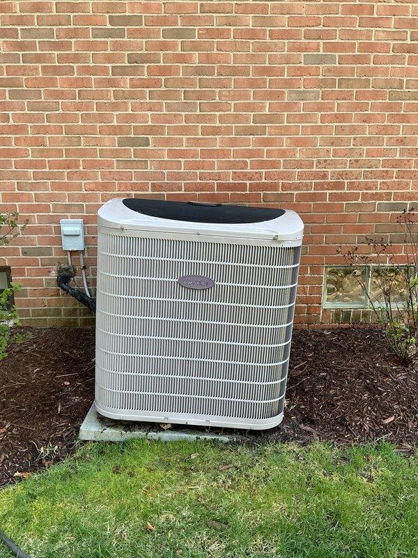 Completed comprehensive tune-up on 2016 residential HVAC system including outdoor condenser unit and basement components. Performed thorough inspection of air conditioning condenser, humidifier, thermostat, and hot water tank, verifying proper operation of all equipment. Documented unit condition with photos showing condenser in functional status with intact fan assembly and proper clearances maintained around outdoor unit.