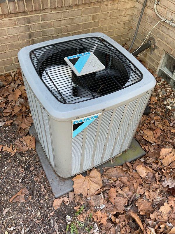 Completed comprehensive Gold AC inspection on 5-year-old Daikin residential air conditioning system with air handler located in basement. Performed multi-point inspection including examination of outdoor condenser unit, coil assembly, refrigerant lines, electrical connections, and all accessible system components. System found to be operational with normal wear patterns; noted leaf debris accumulation around condenser unit exterior requiring routine maintenance attention.