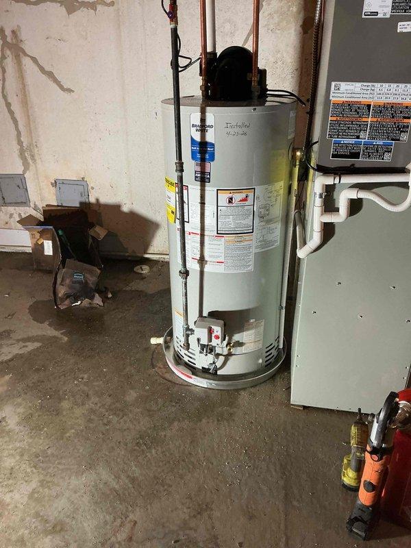 Completed installation of a 50-gallon power vent water heater in basement utility room. Removed existing unit and installed new tank-style water heater with power vent assembly, connecting copper supply lines and establishing proper venting through PVC exhaust system. Reconnected all plumbing connections, verified proper operation of the power vent motor, and ensured system met manufacturer specifications and local code requirements.