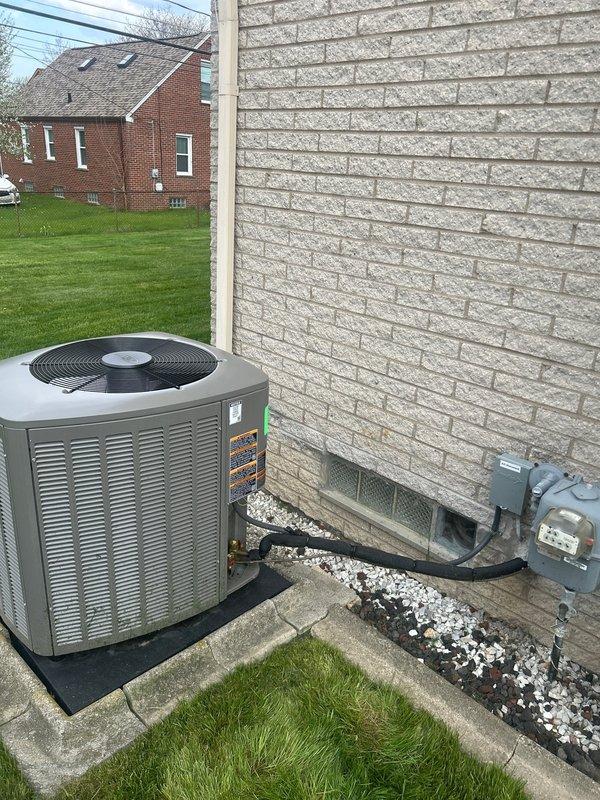 Completed AC system startup for basement air conditioning unit. Performed comprehensive startup inspection of outdoor condenser unit positioned on rubber isolation pad with proper electrical disconnect and conduit installation. Verified thermostat operation and temperature control functionality, confirmed system responding appropriately to setpoint adjustments with digital White-Rodgers control displaying proper readings and cycling between heating, cooling, and fan modes as designed.