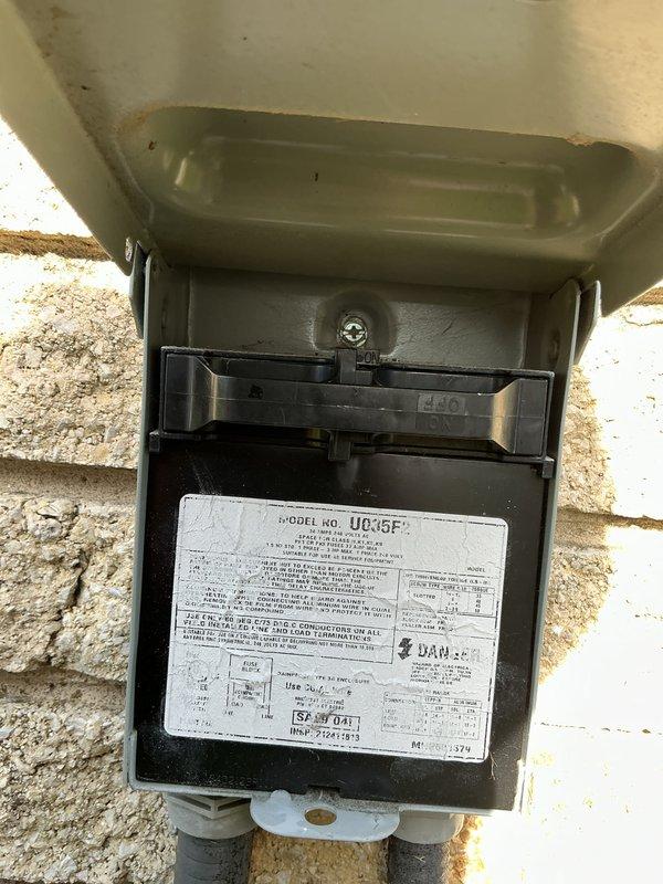 Completed comprehensive Gold AC inspection on residential cooling system. Unit confirmed operational at time of service. Performed thorough evaluation of outdoor condenser unit, including visual inspection of fan assembly, housing condition, and proper placement on concrete pad. Inspected electrical disconnect box mounted on exterior wall, verified accessibility and condition of disconnect mechanism and fuse holder. Air handler and evaporator coil located in basement area. Documented equipment condition through photographic records showing exterior disconnect components with visible specification plate and outdoor condenser unit positioned in backyard setting. Provided estimate for thermostat replacement as requested. System operating normally with no immediate service concerns identified during inspection.