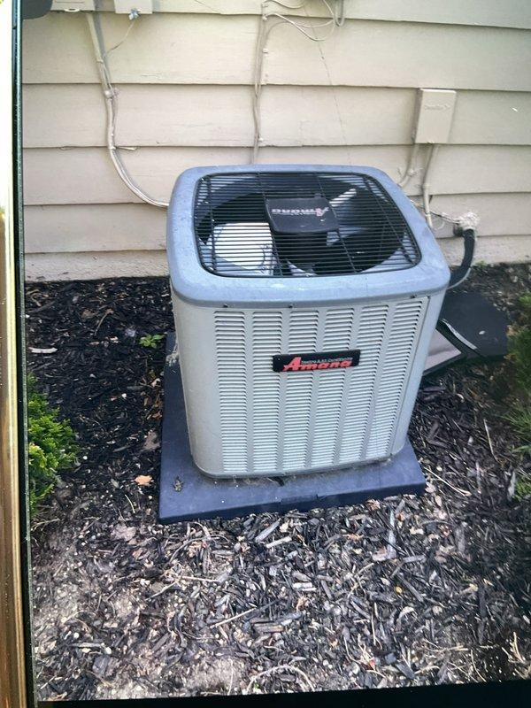 Completed comprehensive inspection and preventive maintenance on 7-year-old Amana air conditioning system and hot water tank. AC unit inspection included examining outdoor condenser positioned on concrete pad, verifying proper refrigerant line connections, checking electrical conduit and disconnect box functionality, and assessing overall equipment condition. Confirmed unit operational status with no immediate concerns noted. Performed hot water tank flush to remove sediment buildup and maintain heating efficiency. All equipment found to be in working order with appropriate weathering for age and outdoor exposure.