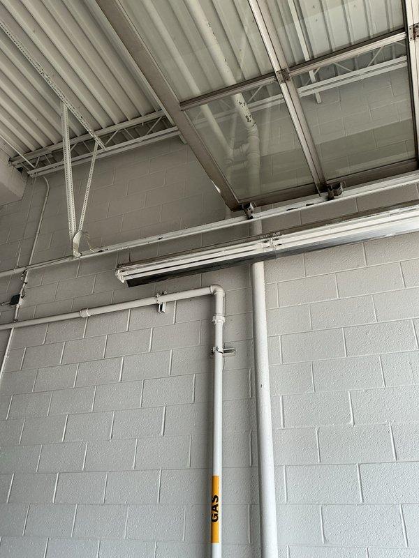 Responded to commercial property for gas pressure test following city-identified gas leak at exterior meter assembly. Performed comprehensive pressure test on gas piping system from exterior meter location through interior distribution lines. Inspected exterior gas meter installation, regulator assembly, and associated piping mounted on building exterior, noting staining at concrete pad base. Evaluated interior gas piping system including vertical runs and horizontal distribution lines throughout facility. Completed pressure test protocol to verify system integrity and identify any leak points in accordance with municipal requirements for gas service restoration.