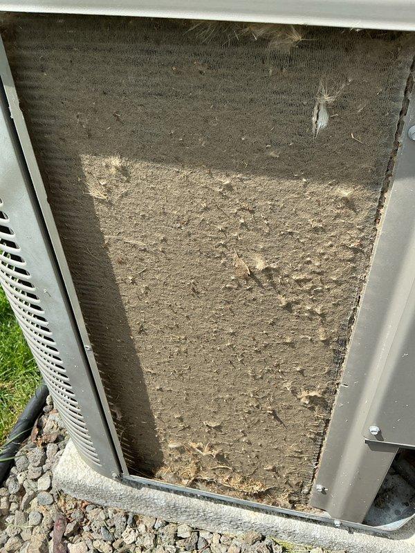 Completed comprehensive tune-up on 8-year-old HVAC system with basement coil configuration. Performed thorough inspection of outdoor condenser unit, indoor air handler, humidifier, thermostat, and hot water tank as part of early bird seasonal maintenance program. Discovered heavily soiled air filter with significant accumulation of dust, dirt, and debris restricting airflow—filter replaced to restore proper system operation. Inspected condenser unit exterior components including fan grille, louvered panels, electrical disconnect, and refrigerant line set. Verified unit mounting on concrete pad and checked grounding connections. System operational following filter replacement and standard maintenance procedures completed.