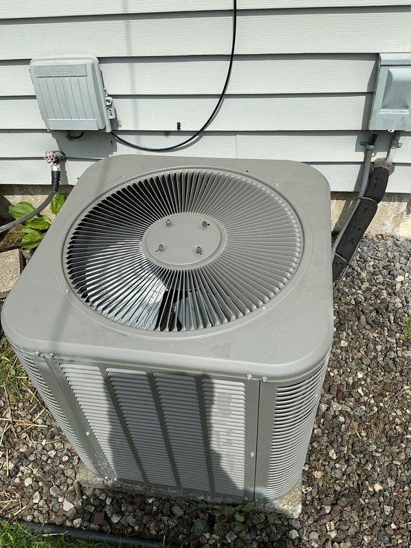 Completed comprehensive tune-up on 8-year-old HVAC system with basement coil configuration. Performed thorough inspection of outdoor condenser unit, indoor air handler, humidifier, thermostat, and hot water tank as part of early bird seasonal maintenance program. Discovered heavily soiled air filter with significant accumulation of dust, dirt, and debris restricting airflow—filter replaced to restore proper system operation. Inspected condenser unit exterior components including fan grille, louvered panels, electrical disconnect, and refrigerant line set. Verified unit mounting on concrete pad and checked grounding connections. System operational following filter replacement and standard maintenance procedures completed.