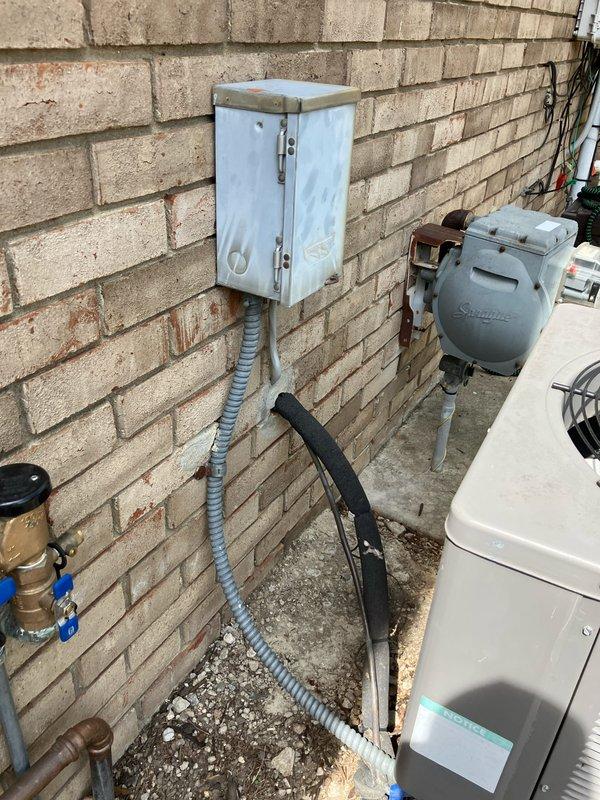 Provided estimate for replacement of aging outdoor AC condenser unit located on exterior concrete pad alongside building. Existing unit is operational but over 10 years old, with associated basement furnace equipment running on natural gas. Documented current system configuration including refrigerant lines, electrical disconnect, and utility connections for replacement specifications.
