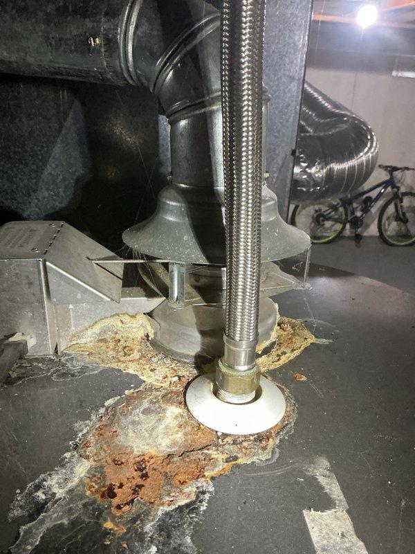 Completed comprehensive tune-up service on 17-year-old furnace and air conditioning system located in basement. Both units confirmed operational at time of inspection. Notable finding: significant rust and corrosion observed at base of equipment with white mineral deposits indicating historical moisture exposure or water damage around foundation area. Whirlpool branded water heater also present in mechanical room showing normal wear patterns. All systems currently functioning as designed, though age of equipment and corrosion patterns warrant monitoring for future service needs.
