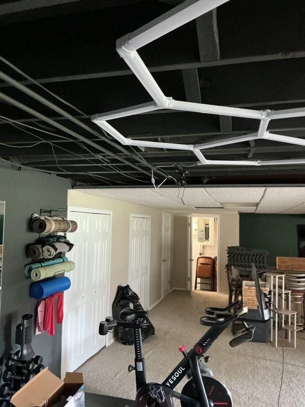 Conducted site evaluation for new mini-split installation in two upstairs bedrooms. Assessed exterior mounting location for condensing unit near existing HVAC equipment and evaluated interior spaces including basement area for potential line set routing through exposed ceiling joists. Documented existing conditions and confirmed feasibility for dual-zone ductless system installation.