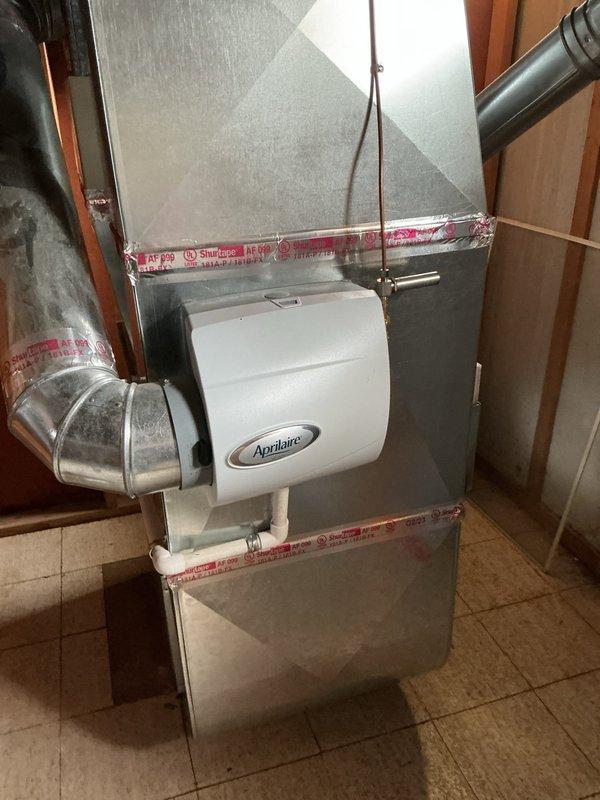 Completed Gold AC Inspection on 3-year-old system with evaporator coil located in basement. Responded to service call regarding air conditioning unit not turning on and thermostat not registering system status. Performed comprehensive diagnostic evaluation of HVAC system including thermostat communication, electrical connections, control board functionality, and refrigerant circuit. Inspected Aprilaire humidifier integration with ductwork system and verified proper installation of drain lines and PVC plumbing connections. Assessed all mechanical components, ductwork integrity, and system controls to identify root cause of operational failure and restore cooling functionality.