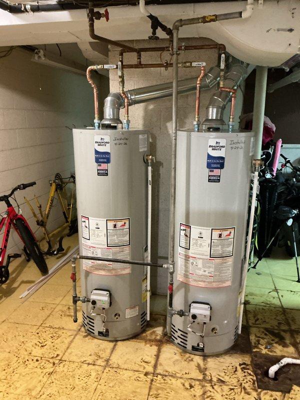 Completed installation of two Bradford White tanked water heaters in basement utility area. Established all copper supply line connections with proper valves and shutoffs, installed expansion tanks on both units, and configured complete hot water distribution system. Reconnected all plumbing infrastructure, tested for proper operation and verified no leaks at connections or fittings.