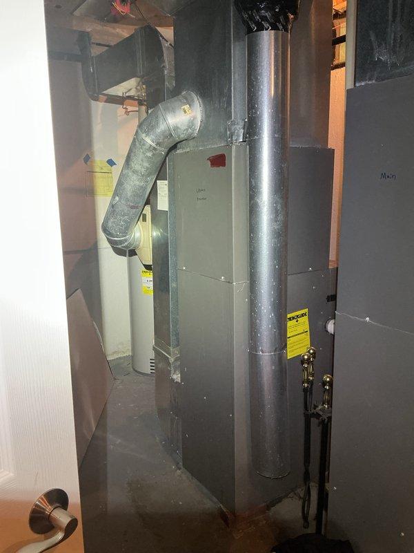 Completed comprehensive Gold-level furnace and air conditioning inspection on multi-unit property with four HVAC systems, all over 10 years old. Performed thorough examination of basement-located air handler, furnace unit, humidifier system, and associated ductwork. Inspected all mechanical components, verified proper operation of heating and cooling equipment, checked electrical connections, examined copper piping and valve assemblies, and assessed overall system condition including ductwork integrity and airflow pathways.
