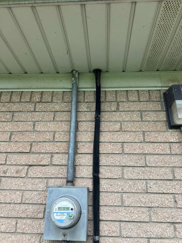 Conducted site assessment for non-operational air conditioning system located in attic space. Evaluated existing equipment condition, verified electrical service connection at exterior meter, and inspected attic access point to provide comprehensive replacement estimate for new AC unit installation.