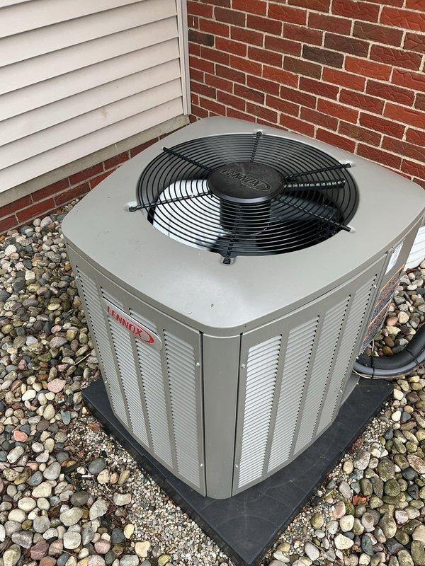 Completed comprehensive Gold AC inspection on a 1-year-old residential air conditioning system with outdoor condenser unit and basement air handler. Performed visual inspection of exterior condenser unit, confirming proper installation on rubber isolation pad with adequate clearance, verified ventilation louvers are unobstructed, and documented equipment condition showing no visible damage, rust, or deterioration. Unit operational with all components functioning within normal parameters.